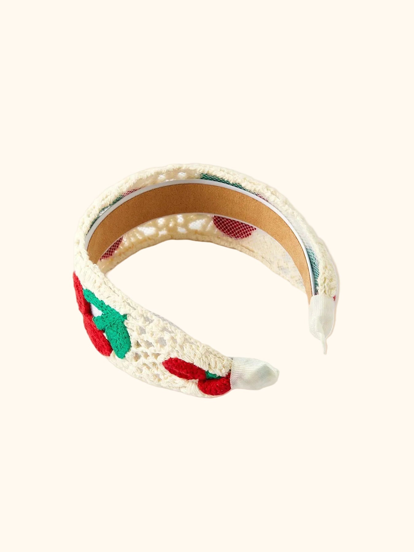 Cream kids cherry crochet headband with wrapped ends, interior three-quarter view