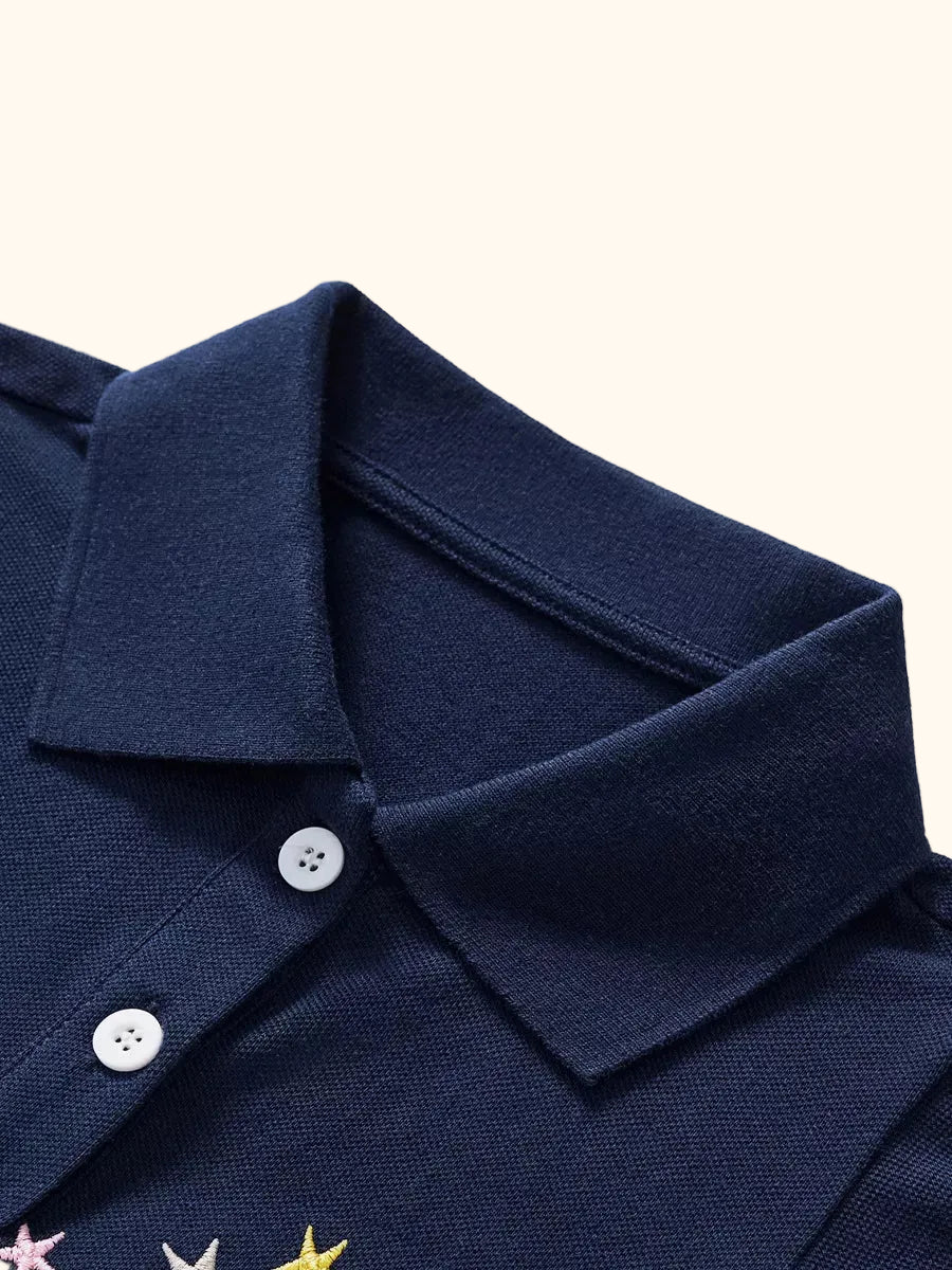Dark navy kids unicorn polo with collar and two-button placket, neckline close-up