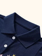 Dark navy kids unicorn polo with collar and two-button placket, neckline close-up