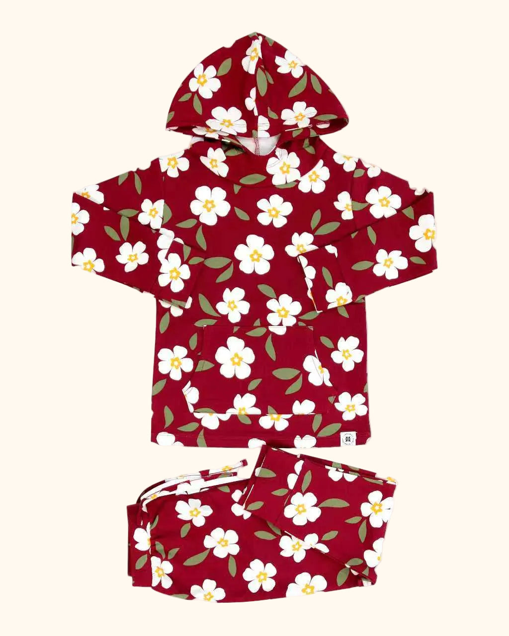Berry red floral hooded top and matching kids jogger pants with white flower print, flat lay view