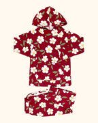 Berry red floral hooded top and matching kids jogger pants with white flower print, flat lay view