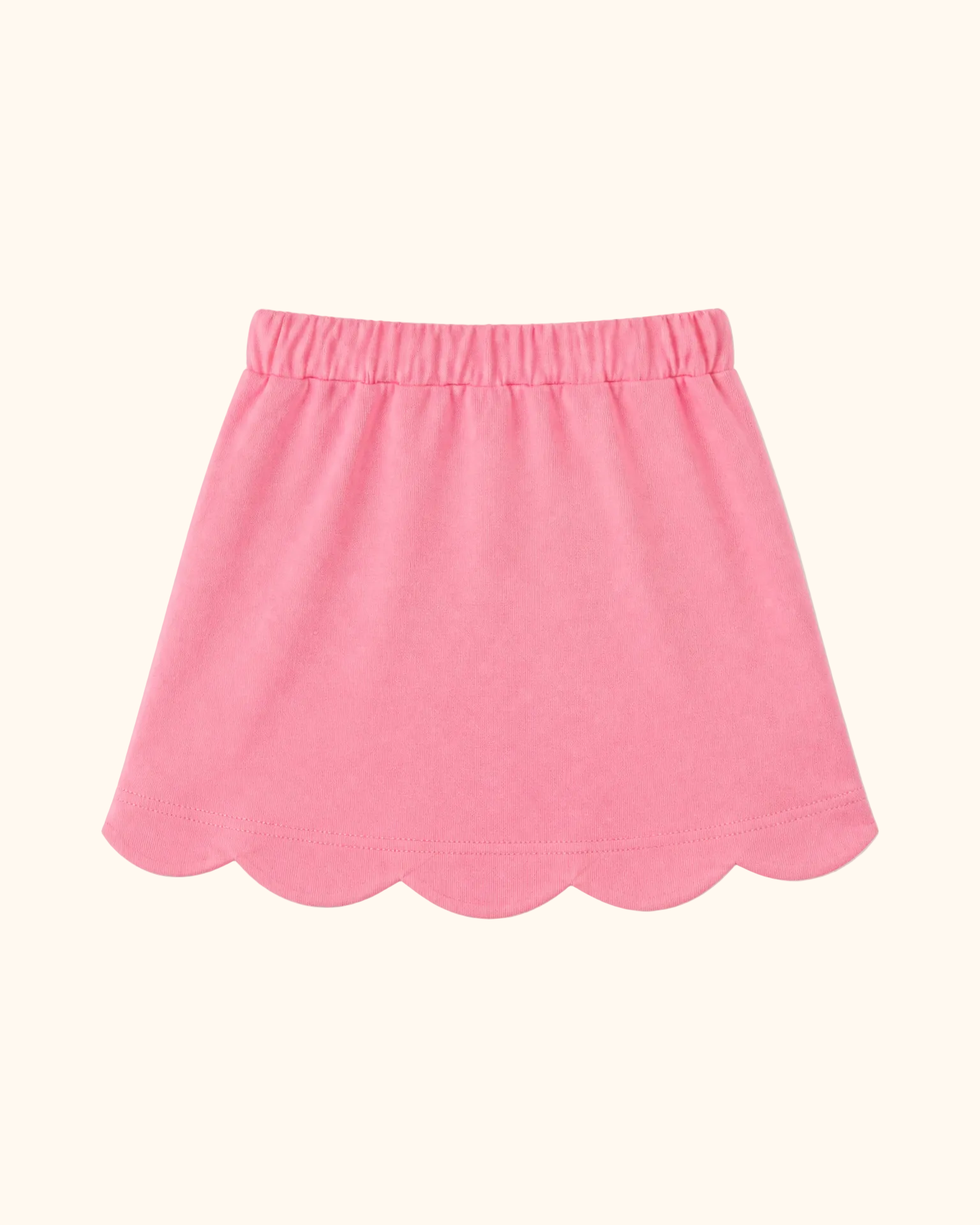 Deep pink kids skort with scalloped hem and elastic waistband, back view