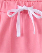 Deep pink kids skort with white bow and elastic waistband, waist detail close-up