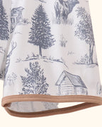 White deer forest print kids shorts with khaki contrast hem trim, close-up view