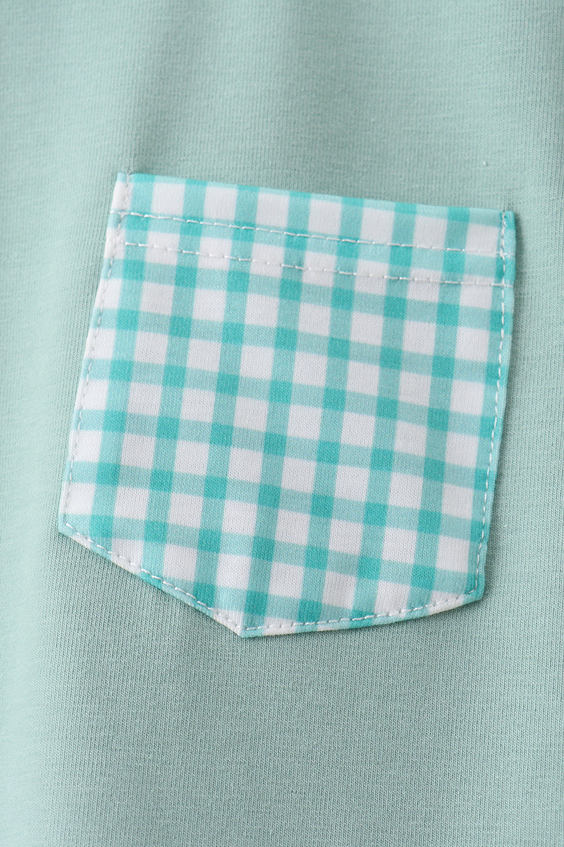 Green kids T-shirt with gingham chest pocket, close-up view