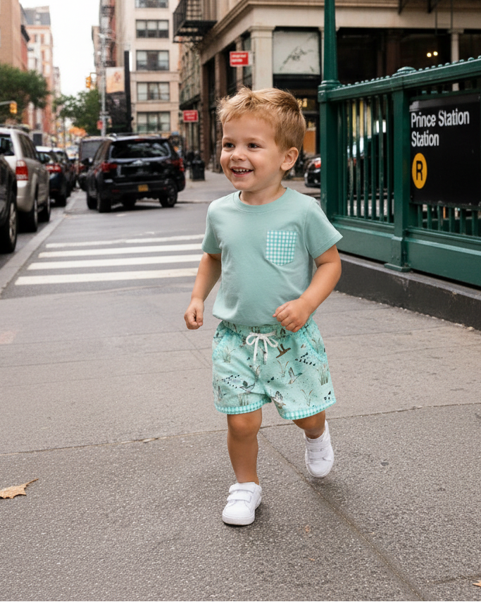Green duck print kids pocket tee and shorts set, outdoor lifestyle view