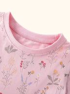 Dusty pink kids floral print dress with allover flower pattern, front detail view