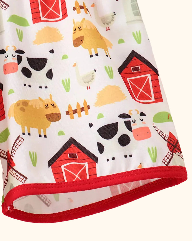 Farm animal print kids shorts with red contrast hem binding, detail view