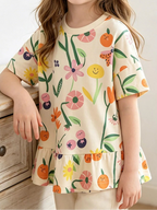 Beige kids floral and fruit print ruffle hem T-shirt worn by child, front lifestyle view
