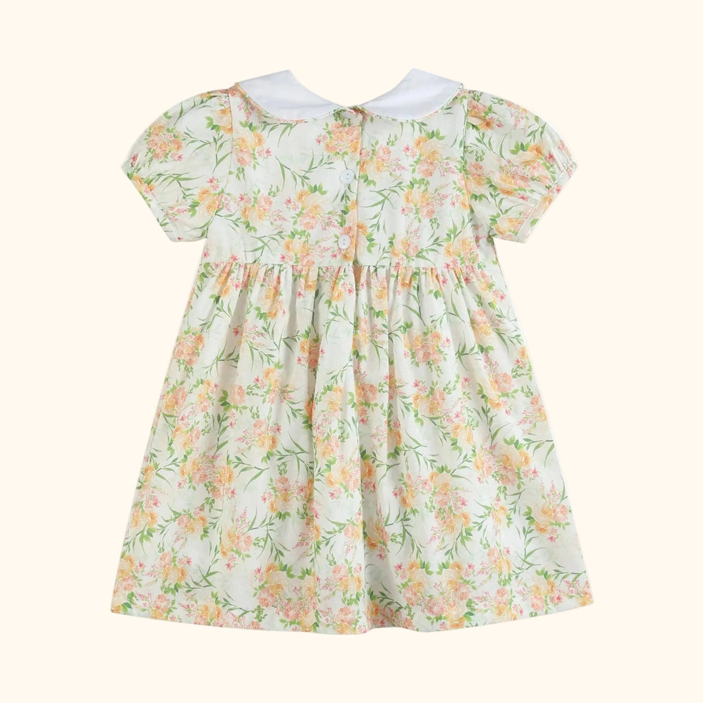 Ivory floral kids smocked dress with white Peter Pan collar and puff sleeves, back product view