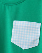 Green kids T-shirt with blue gingham chest pocket, close-up view