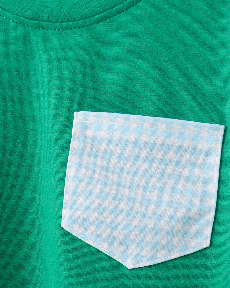Green kids T-shirt with blue gingham chest pocket, close-up view