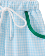 Blue gingham kids shorts with green-trim pockets and white drawstring, close-up view