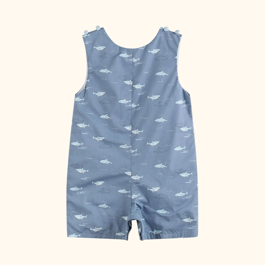 Grey-blue baby shark print shortall with allover sharks and waves, back view