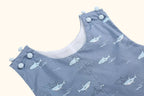 Grey-blue baby shark print shortall with covered shoulder button closures, neckline close-up