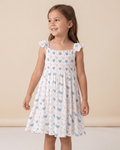 White kids bamboo smocked dress with pastel pink and blue hens, modeled front view