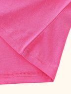 Hot pink kids cotton blend T-shirt with finished hem stitching, fabric detail view