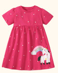 Hot pink kids unicorn appliqué dress with rainbow detail and tiny floral print, front product view