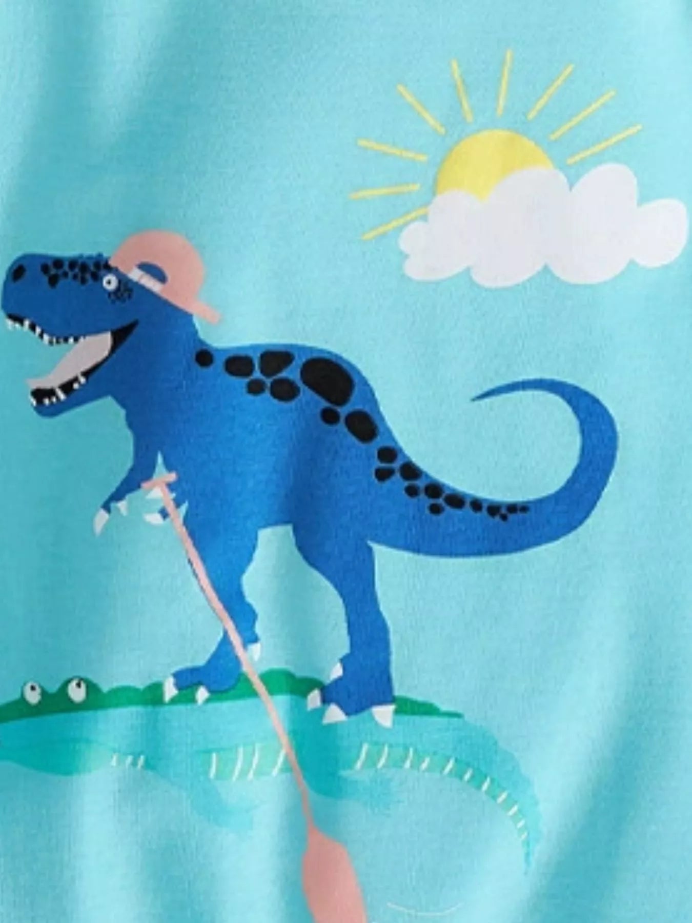 Pastel blue kids T-shirt with blue dinosaur adventure graphic, front design close-up