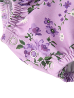Lavender floral baby romper with three-snap crotch closure and elastic leg opening, detail view