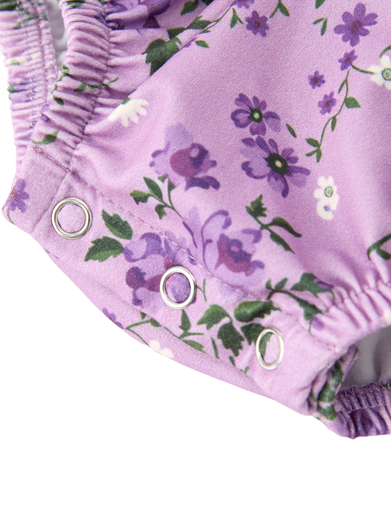 Lavender floral baby romper with three-snap crotch closure and elastic leg opening, detail view
