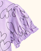 Lavender kids heart print dress with elasticized ruffle sleeve cuff, sleeve detail close-up