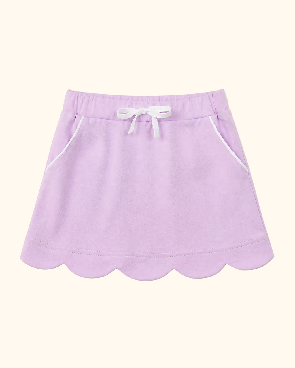 Lavender kids skort with scalloped hem, white bow and piped front pockets, front view