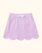 Lavender kids skort with scalloped hem, white bow and piped front pockets, front view