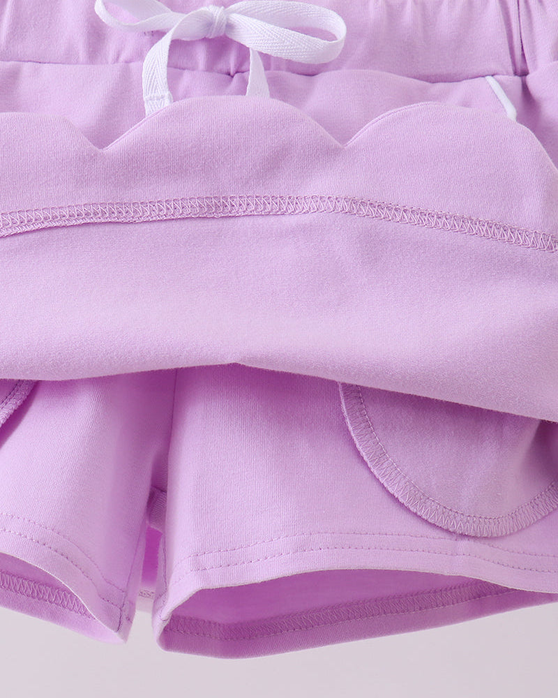 Lavender kids skort with built-in shorts beneath scalloped skirt overlay, interior detail view