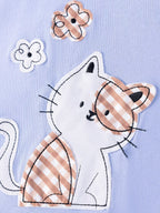 Light blue kids T-shirt with gingham cat appliqué and flower details, design close-up