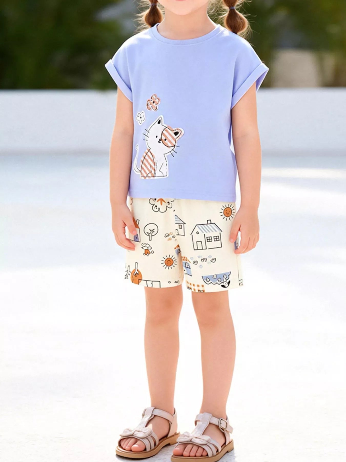 Light blue kids cat appliqué T-shirt and printed shorts set worn by child, front lifestyle view