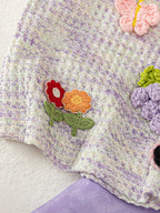 Light purple baby sleeveless top with dimensional butterfly and floral appliqués, detail view