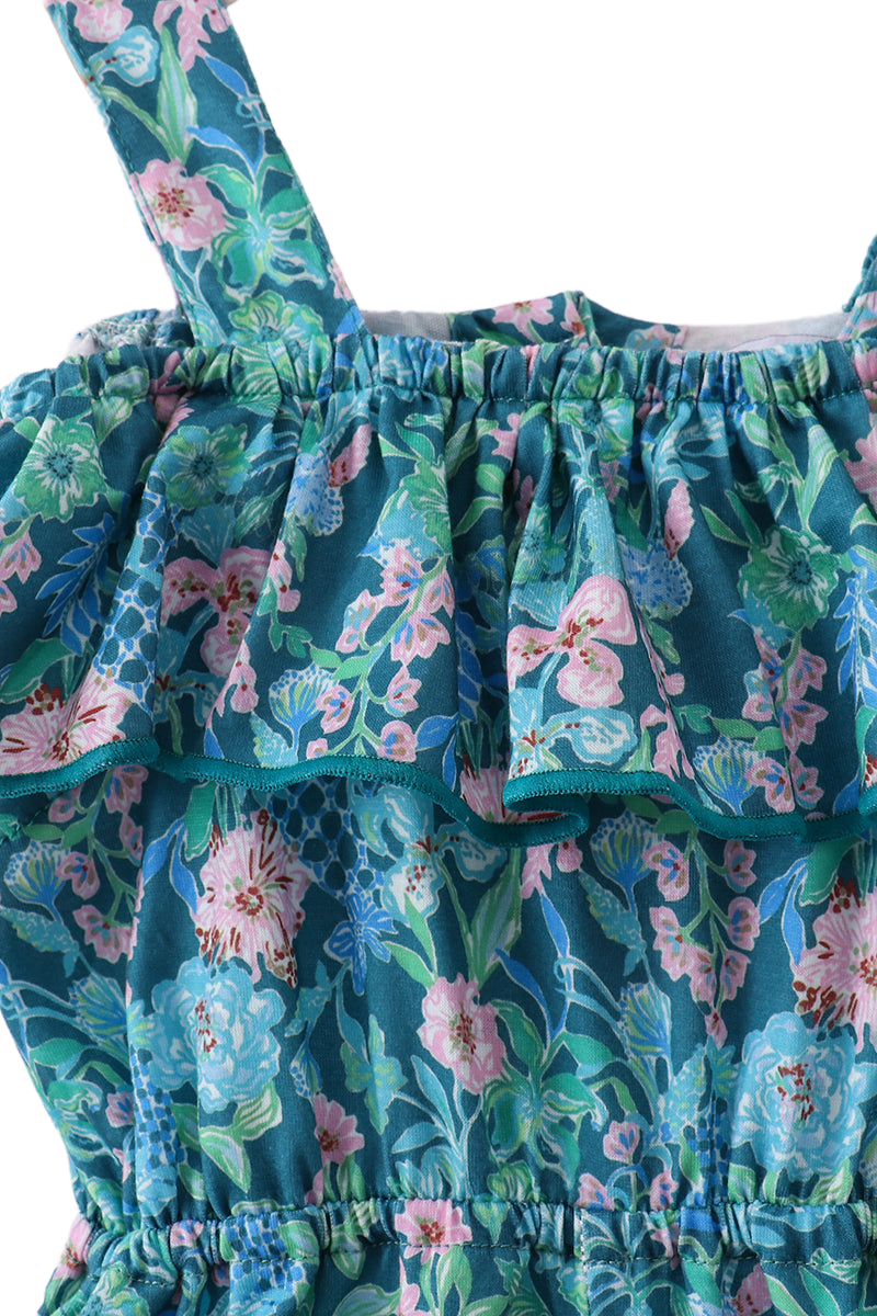 Blue kids floral jumpsuit with wide straps and gathered cold-shoulder ruffle, neckline close-up