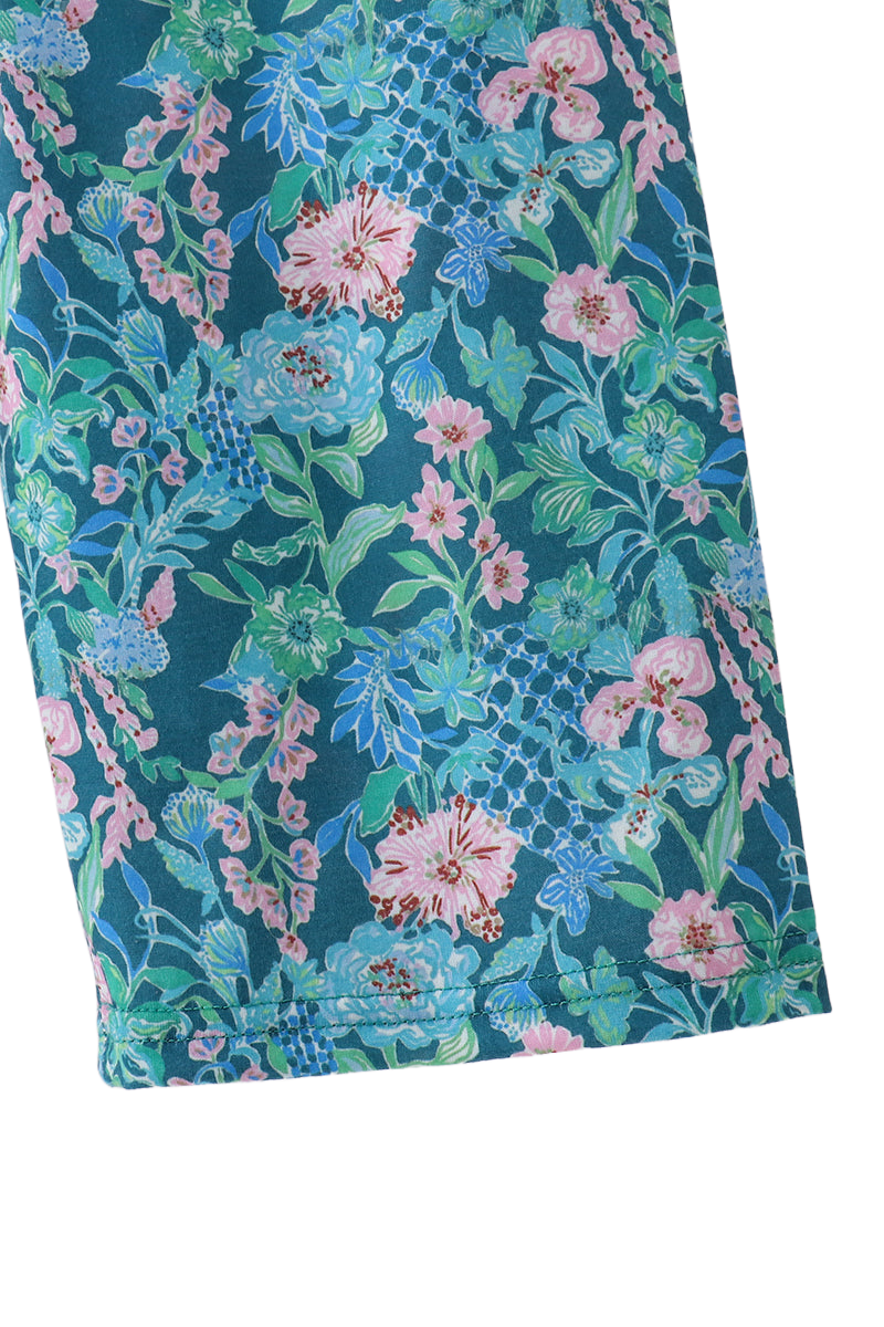 Blue kids floral jumpsuit with pink aqua and green botanical print, pant-leg close-up