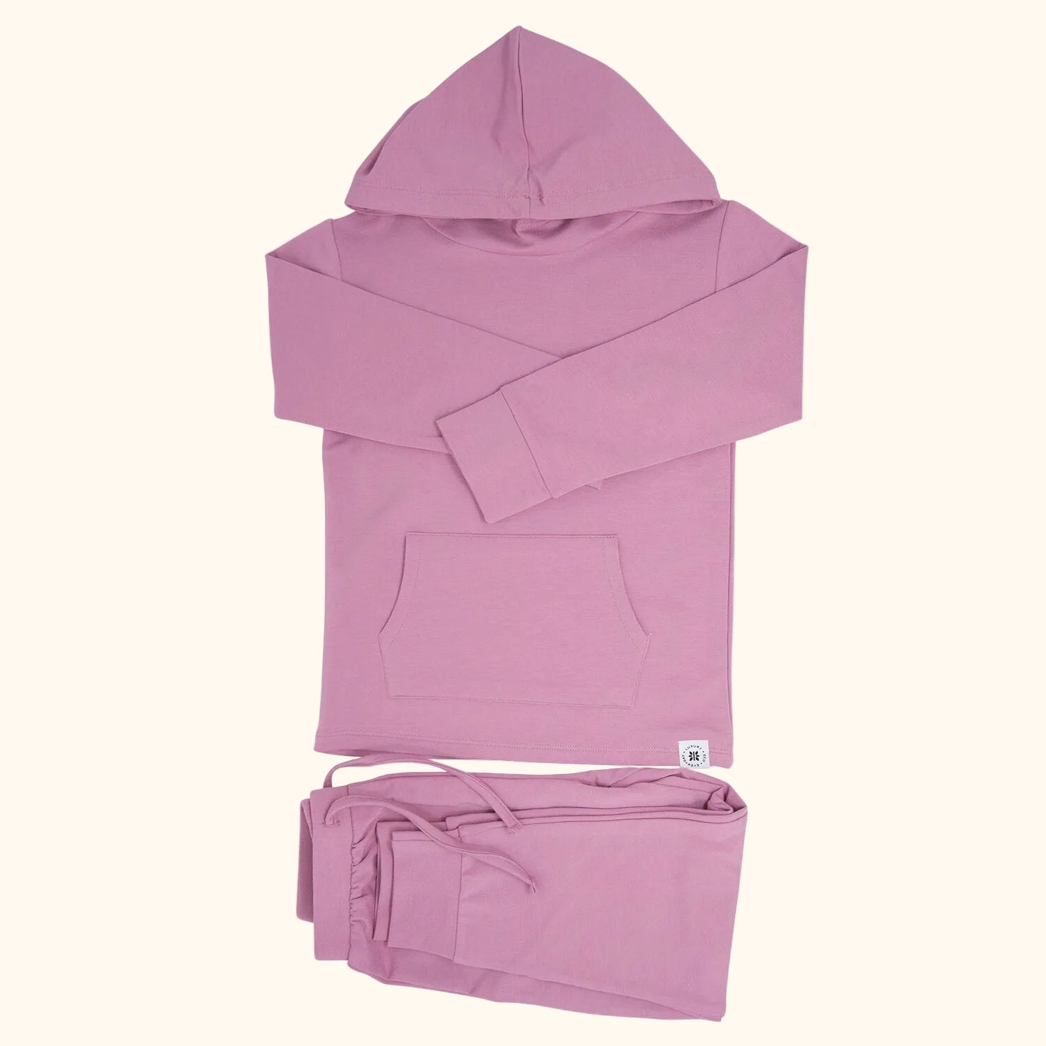 Lotus pink hooded top and matching kids jogger pants with drawstring waist, flat lay view