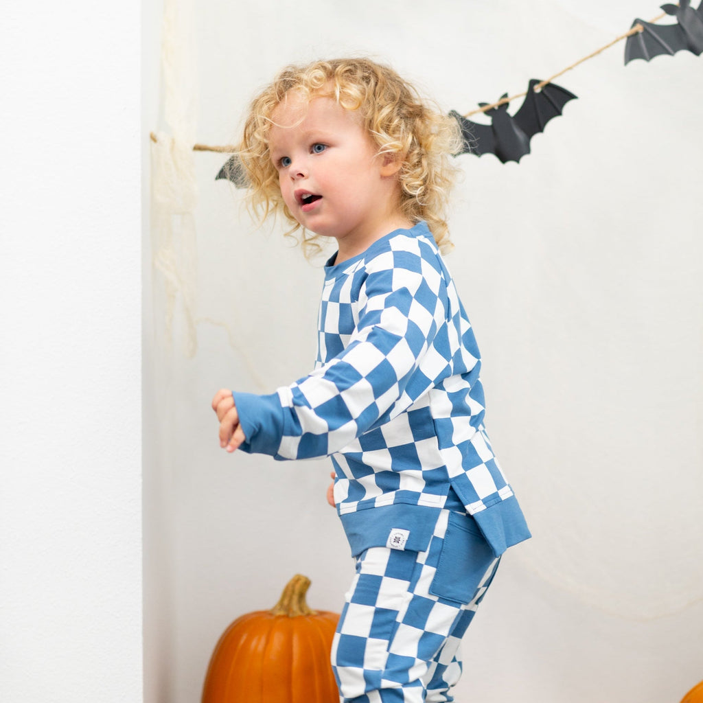 Moody blue checker kids jogger set with matching pants, front side lifestyle view