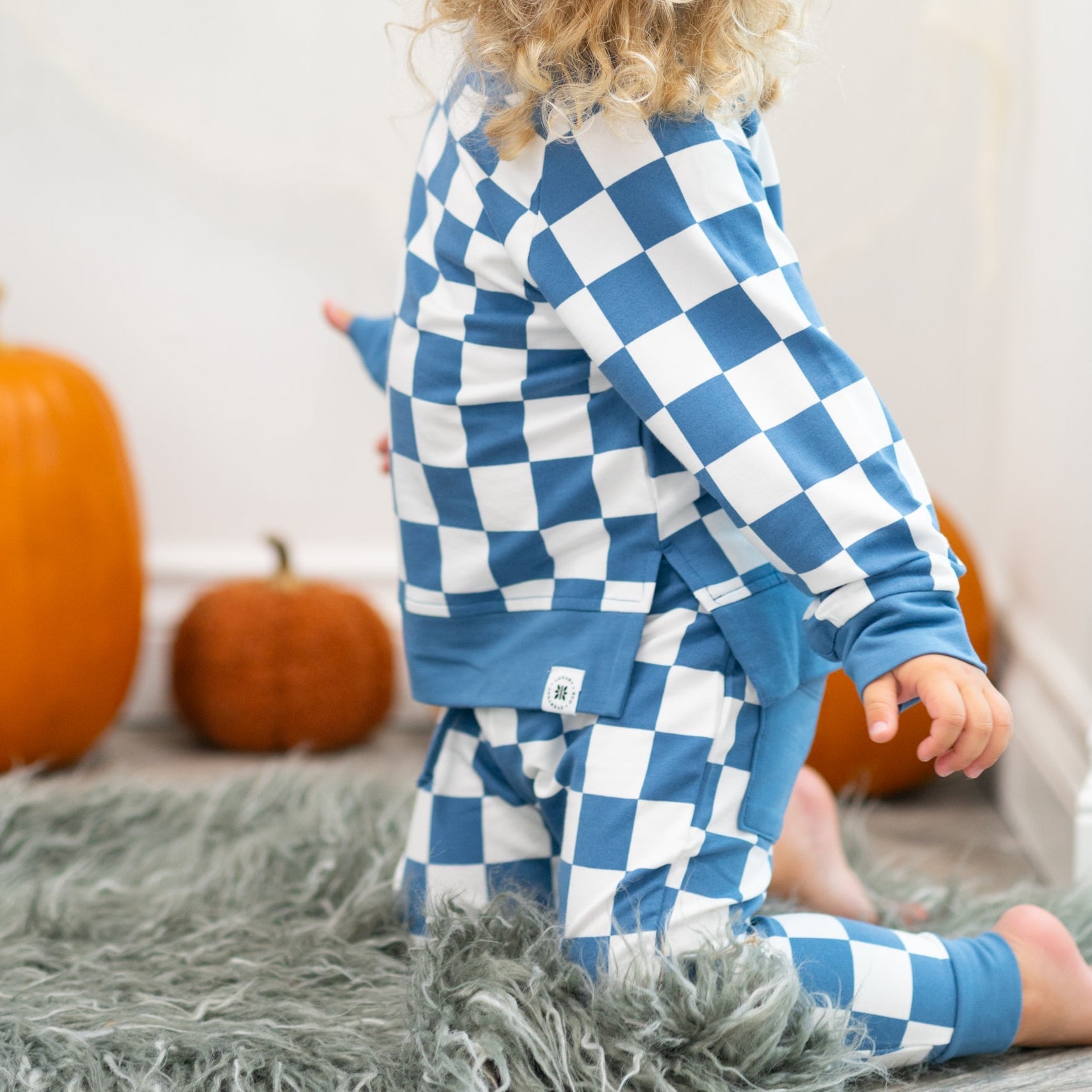 Moody blue checker kids jogger set with solid blue cuffs and pocket detail, side lifestyle view