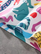 White kids animal print fabric with teal, blue and yellow characters, hem stitching close-up