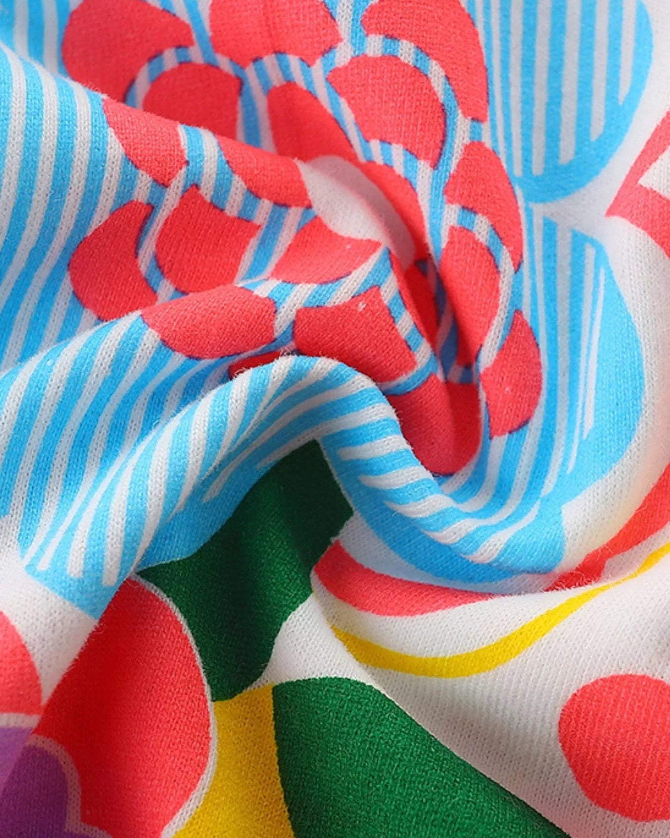 Multicolor kids floral print dress with blue, coral and green pattern, fabric close-up