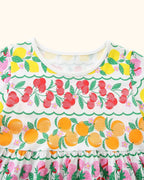 Multicolor kids fruit print dress with white round neckline and colorful fruit rows, bodice close-up