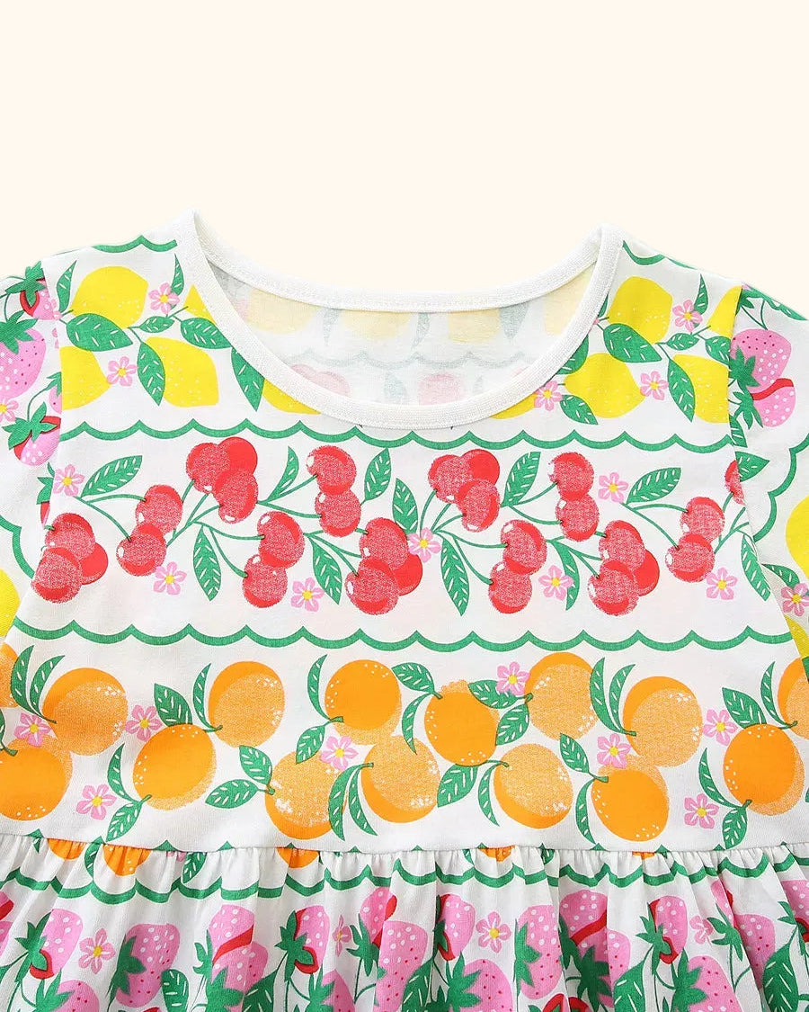 Multicolor kids fruit print dress with white round neckline and colorful fruit rows, bodice close-up