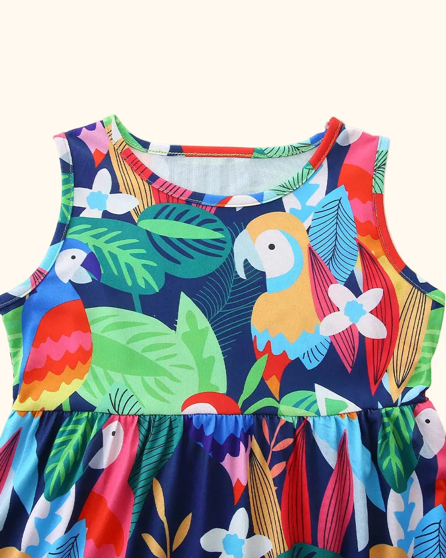 Multicolor kids tropical parrot print dress with round neckline and leafy pattern, upper front close-up