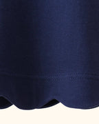 Navy kids flutter sleeve top with scalloped bottom hem, close-up detail view
