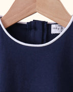 Navy kids flutter sleeve top with white-piped round neckline and back closure, neckline close-up