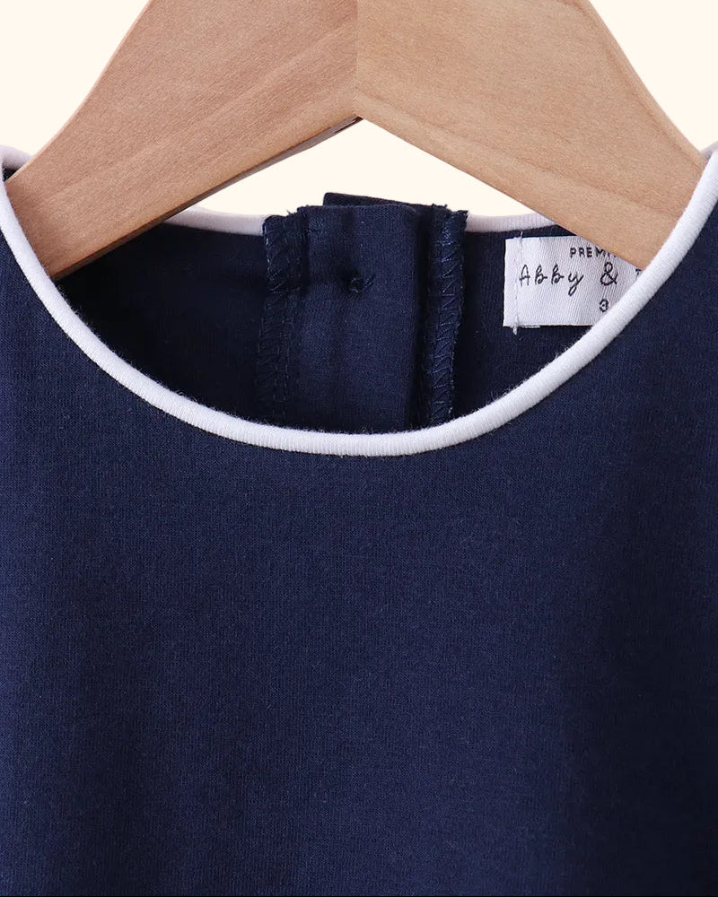 Navy kids flutter sleeve top with white-piped round neckline and back closure, neckline close-up