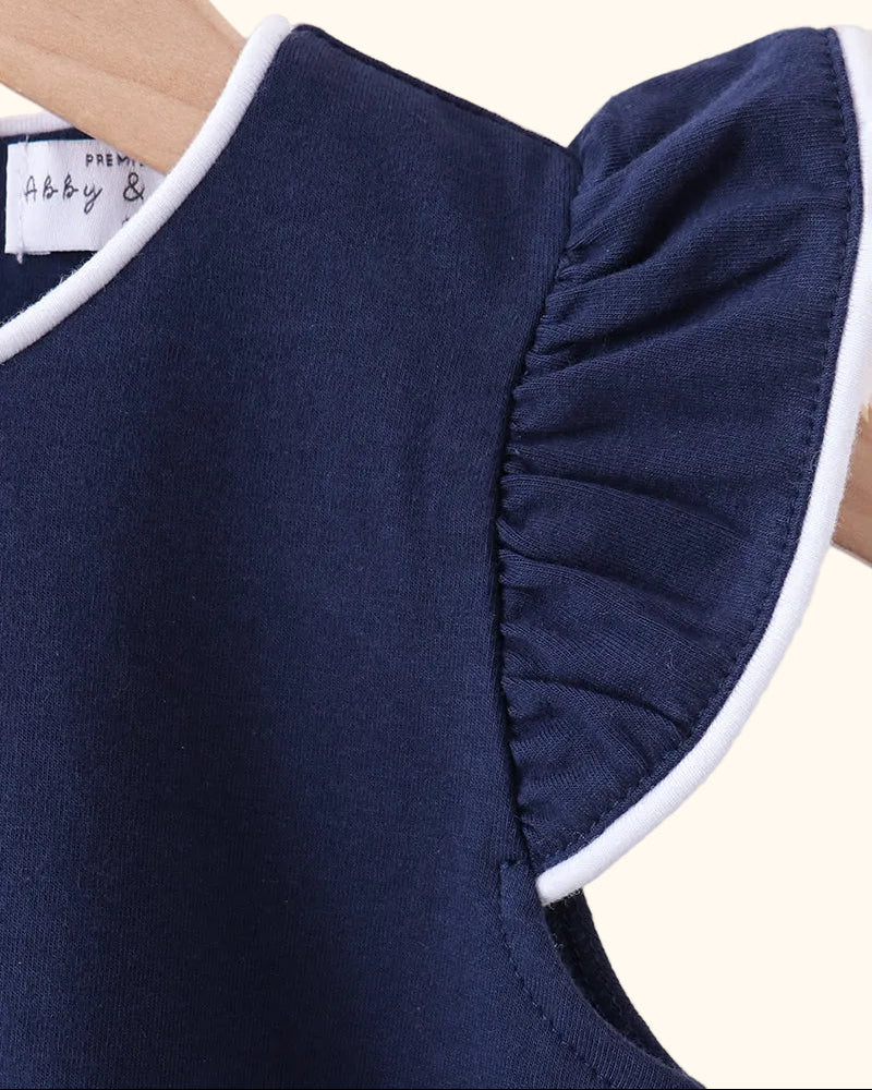 Navy kids flutter sleeve top with white-trimmed flutter sleeve, close-up view