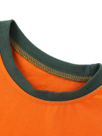 Orange kids dinosaur graphic T-shirt with dark green contrast round neckline, neckline close-up