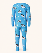 Bright blue kids cow print bamboo pajama set with crescent moons and cuffed pants, back product view