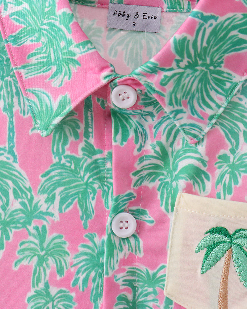 Pink palm tree kids button-down with pointed collar and front buttons, close-up view