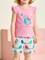 Pink kids bird appliqué top and colorful bird print shorts set worn by child, front lifestyle view
